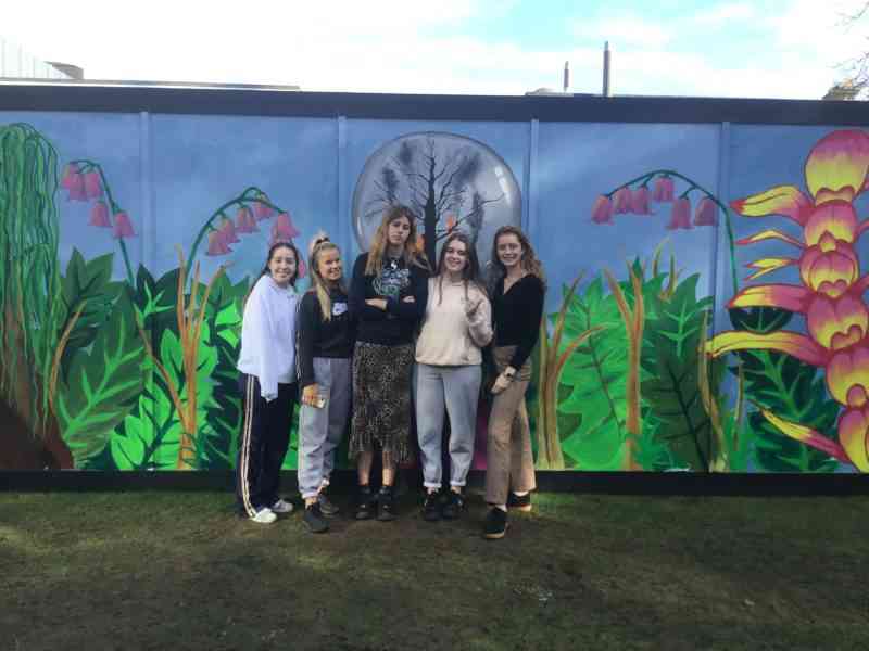 Sixth Form students posing by Putney's Breathe wall